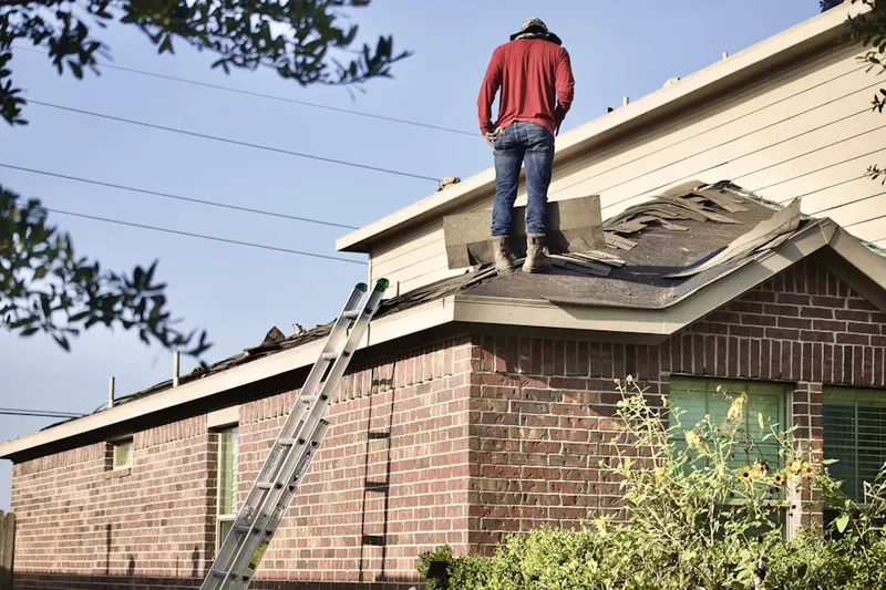 Professional roofer working on a residential roof in Lake Fairview